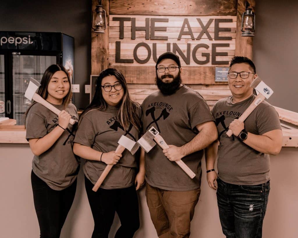axe throwing instructors holding axes at the axe lounge